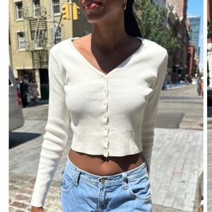 Fitted, button up cardigan in a ribbed, cotton-blend knit with scalloped trim.